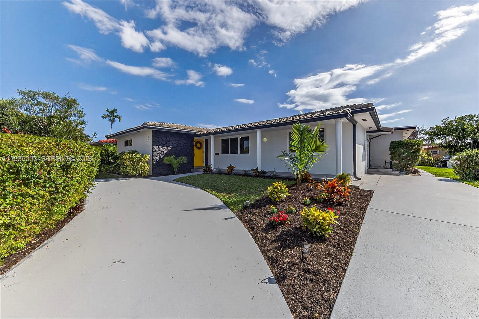 4712 Cleveland Street Hollywood, FL 33021 - Photo 2 of 49 a front view of a house with garden