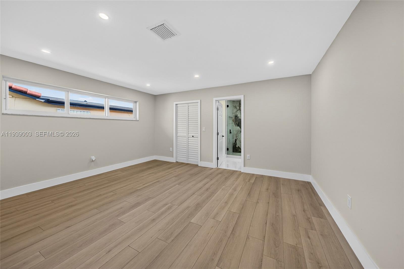 4712 Cleveland Street Hollywood, FL 33021 - Photo 22 of 49 wooden floor in an empty room with a window