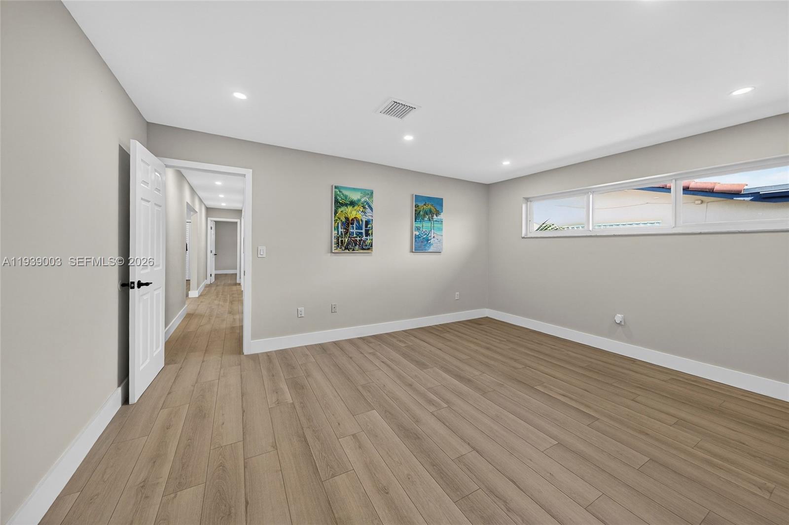 4712 Cleveland Street Hollywood, FL 33021 - Photo 23 of 49 a view of a big room with wooden floor and windows