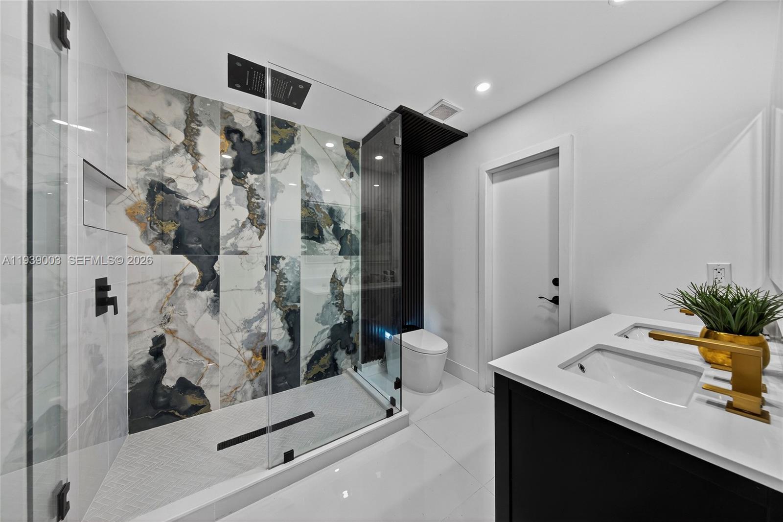 4712 Cleveland Street Hollywood, FL 33021 - Photo 24 of 49 a bathroom with a sink mirror and a shower