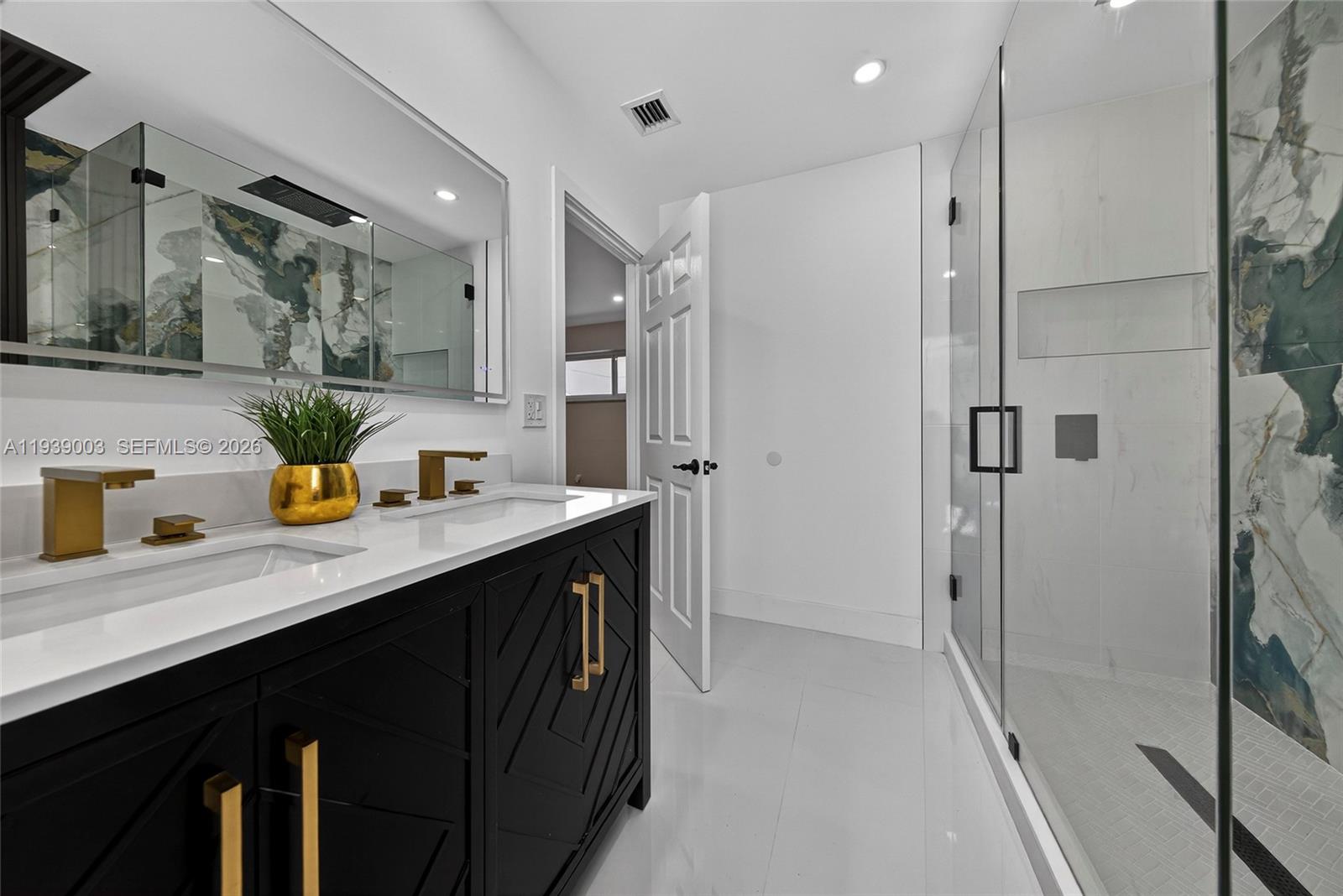 4712 Cleveland Street Hollywood, FL 33021 - Photo 25 of 49 a kitchen with stainless steel appliances a sink and a refrigerator