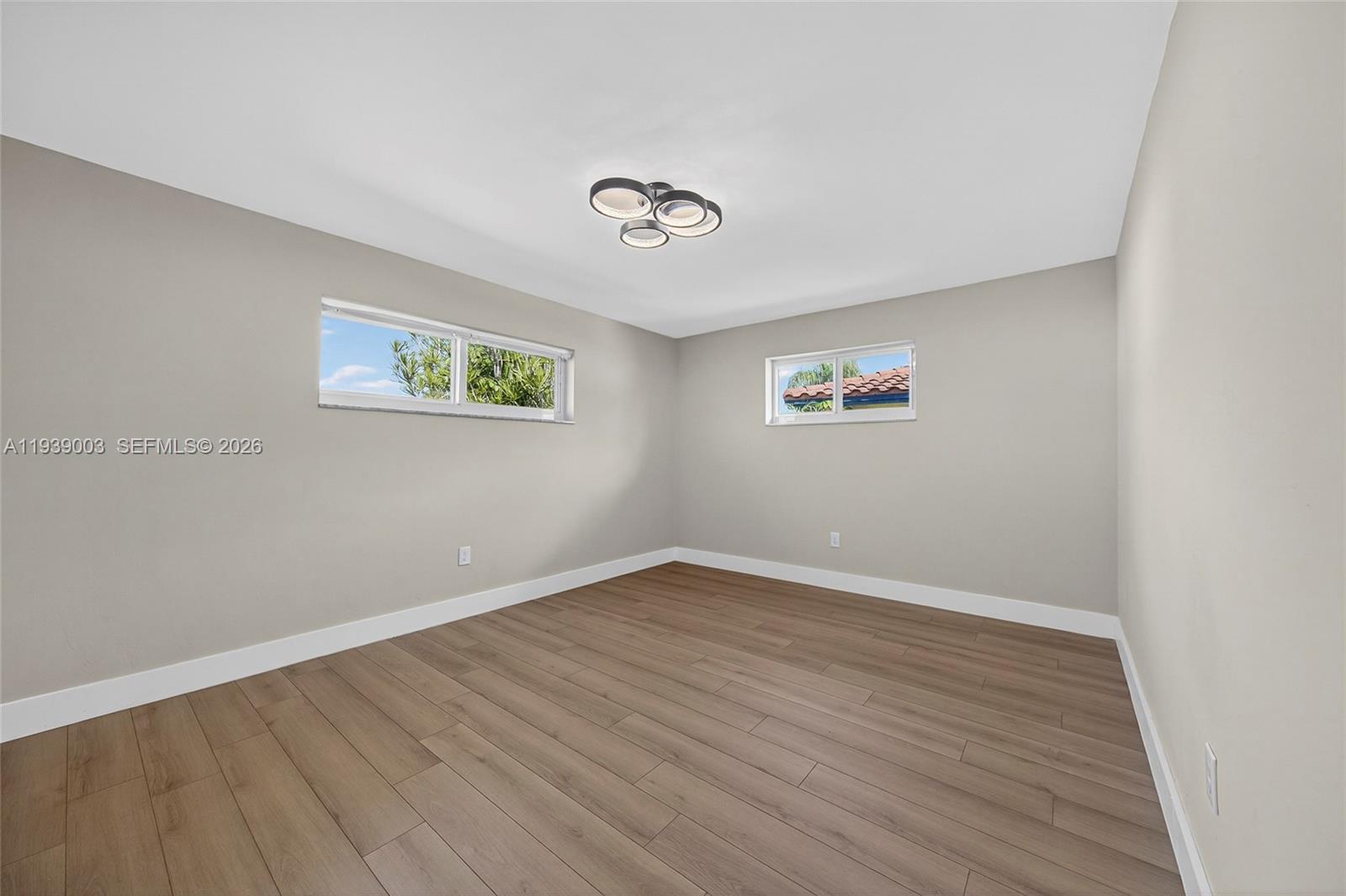 4712 Cleveland Street Hollywood, FL 33021 - Photo 31 of 49 an empty room with wooden floor and window