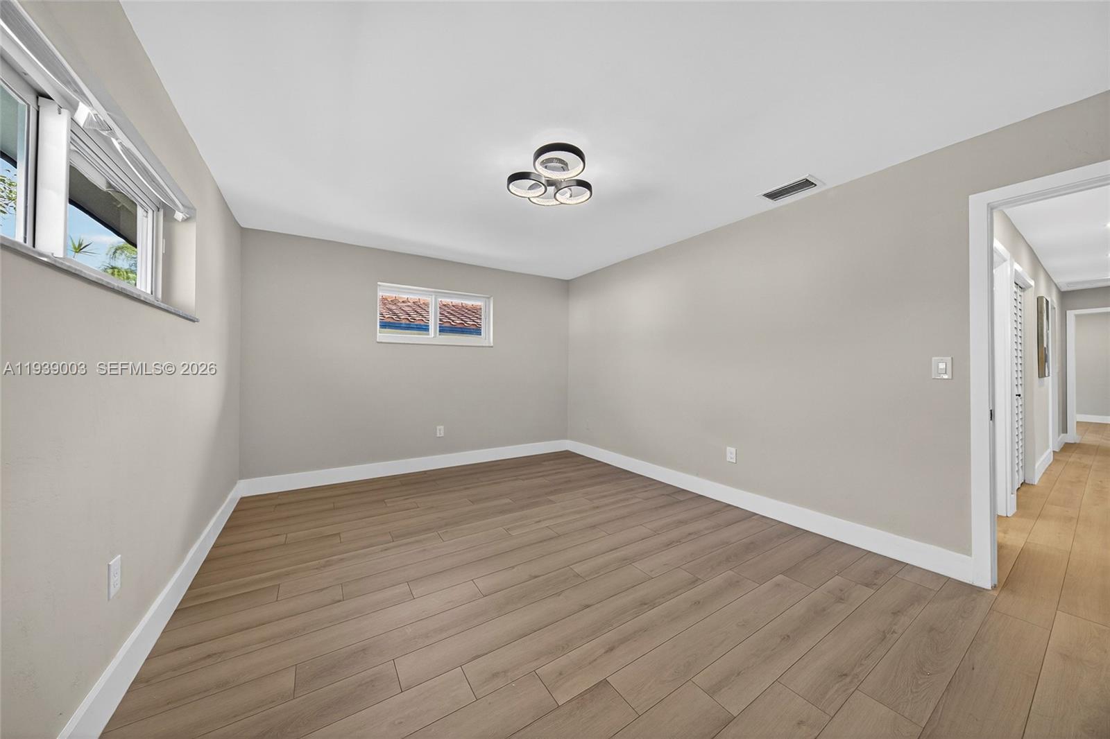 4712 Cleveland Street Hollywood, FL 33021 - Photo 32 of 49 a view of an empty room with wooden floor and a window