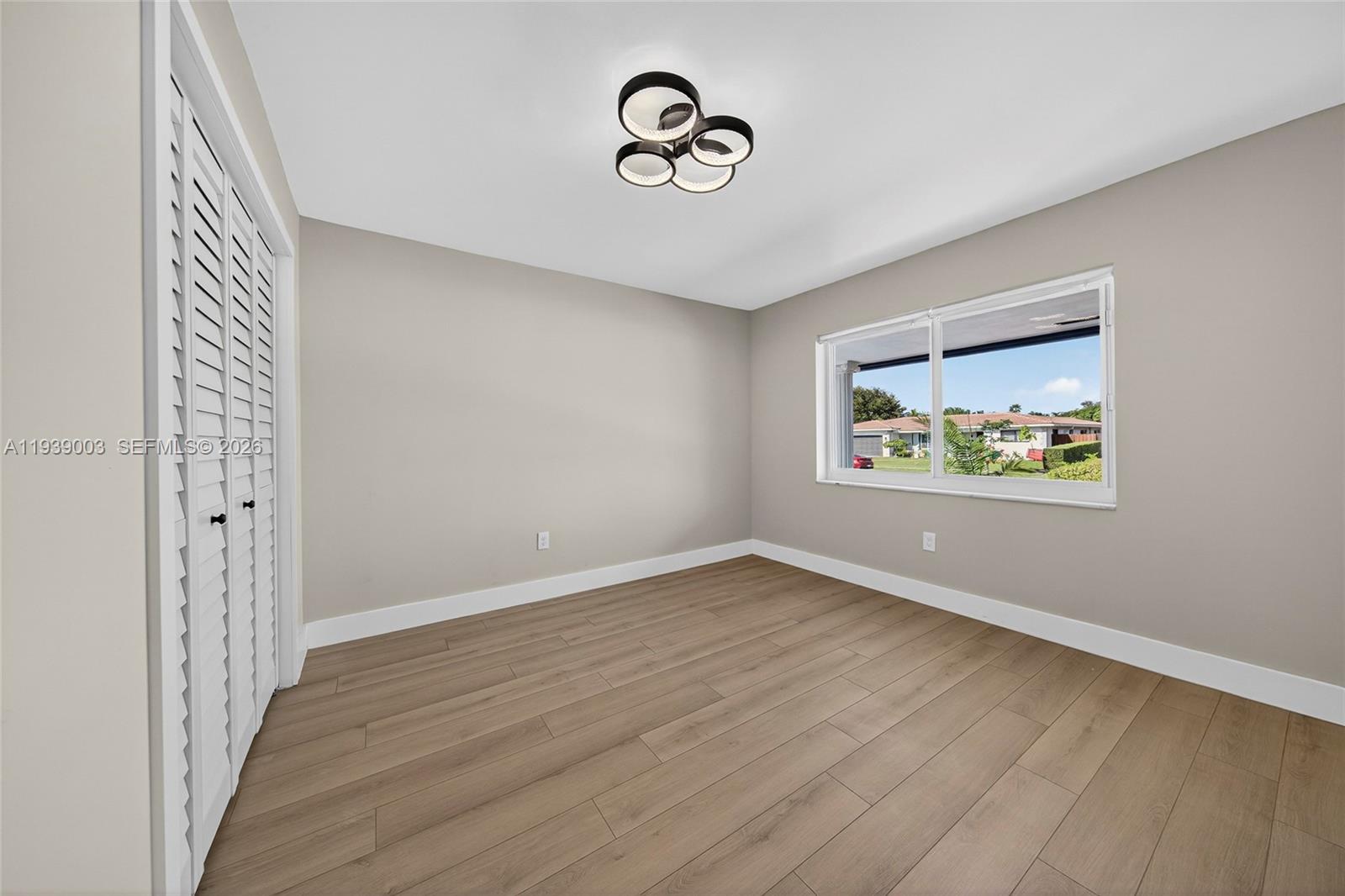 4712 Cleveland Street Hollywood, FL 33021 - Photo 34 of 49 a view of room with window and wooden floor