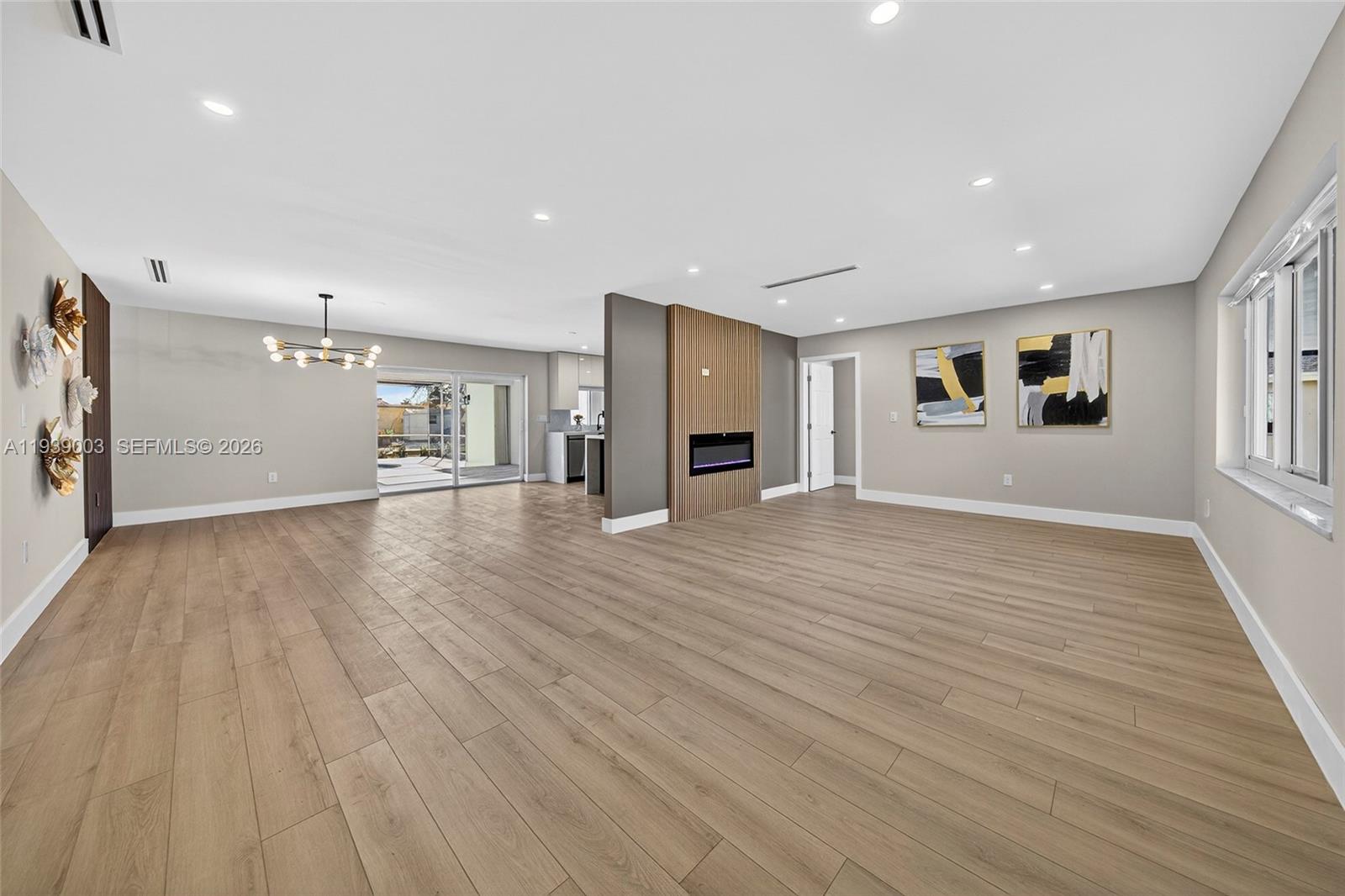 4712 Cleveland Street Hollywood, FL 33021 - Photo 4 of 49 a view of a big room with wooden floor and windows