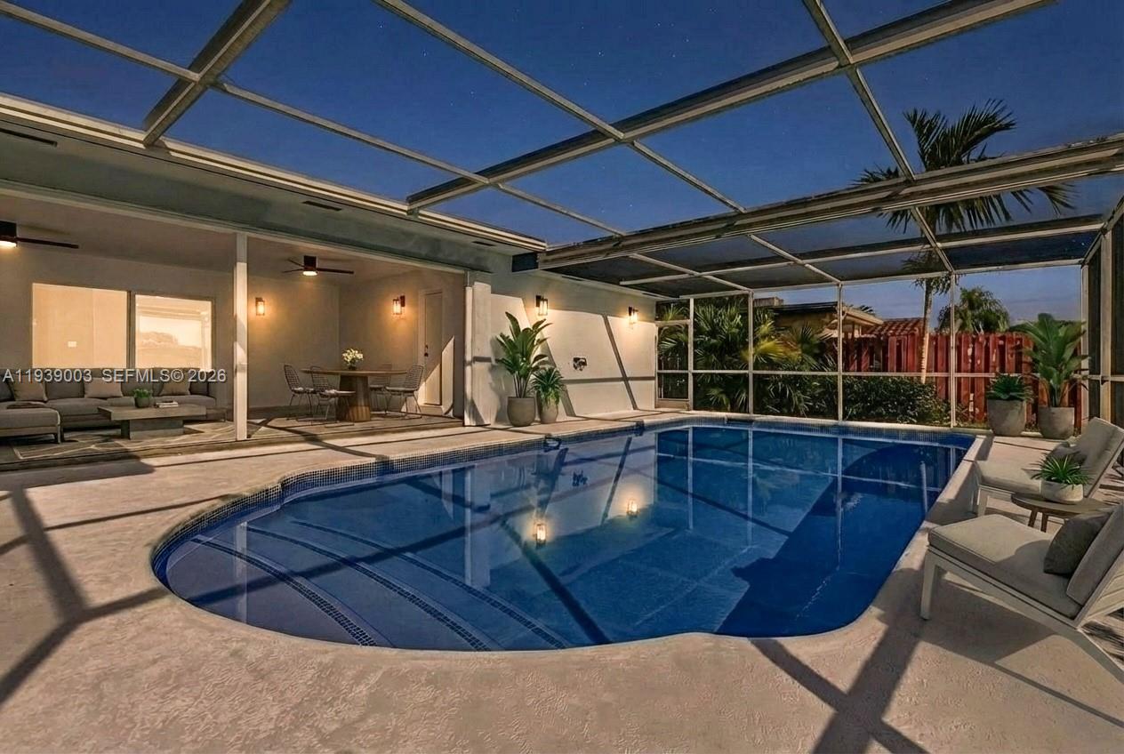 4712 Cleveland Street Hollywood, FL 33021 - Photo 41 of 49 a view of a swimming pool with a lounge chairs