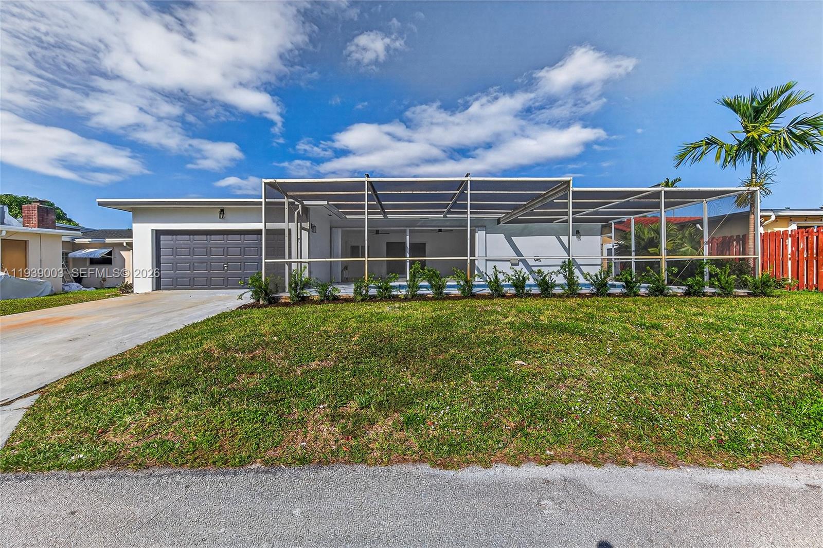 4712 Cleveland Street Hollywood, FL 33021 - Photo 45 of 49 a front view of a house with a yard and outdoor seating
