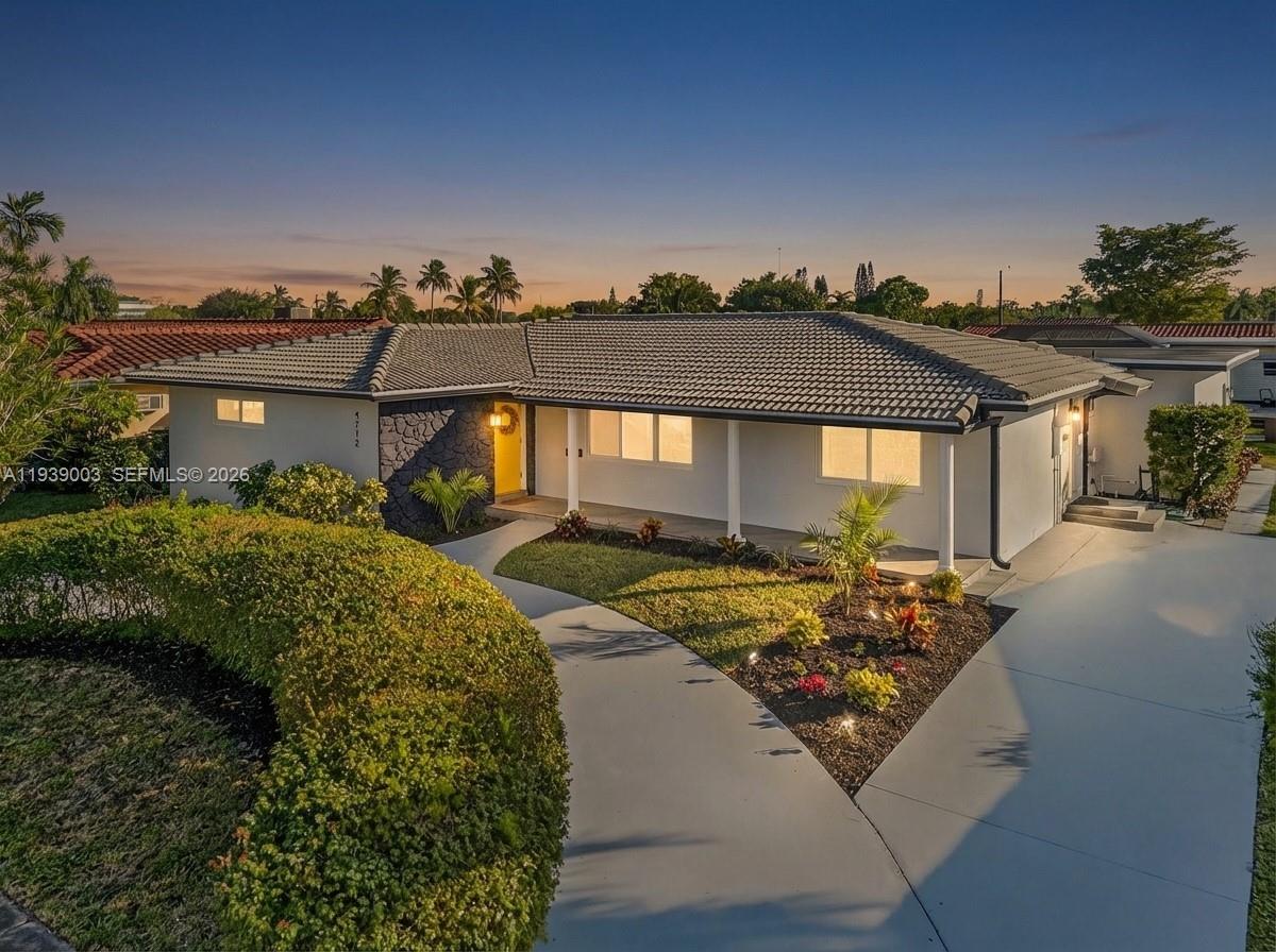 4712 Cleveland Street Hollywood, FL 33021 - Photo 49 of 49 a front view of a house with garden