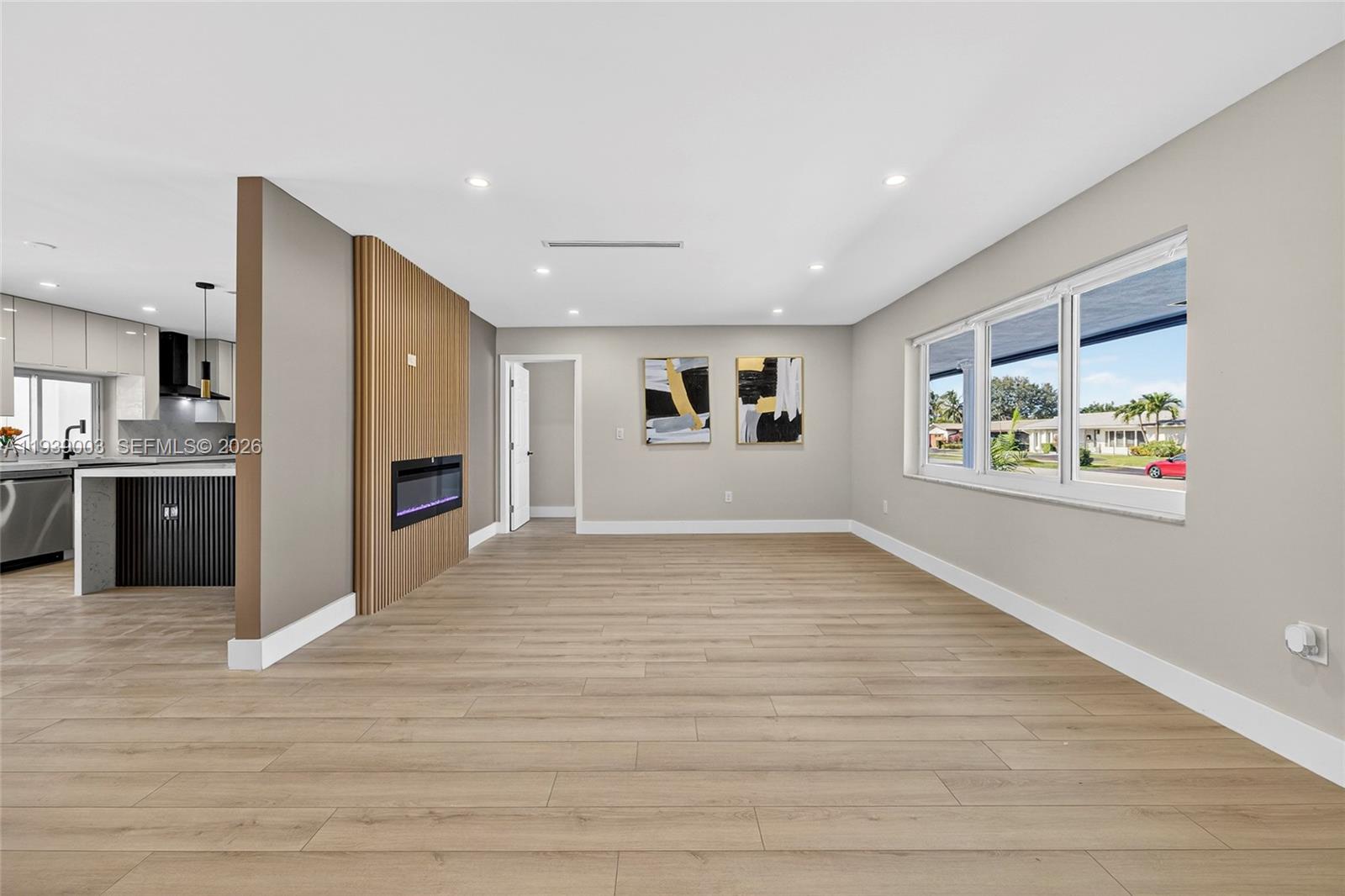 4712 Cleveland Street Hollywood, FL 33021 - Photo 7 of 49 a view of an empty room with a window and wooden floor
