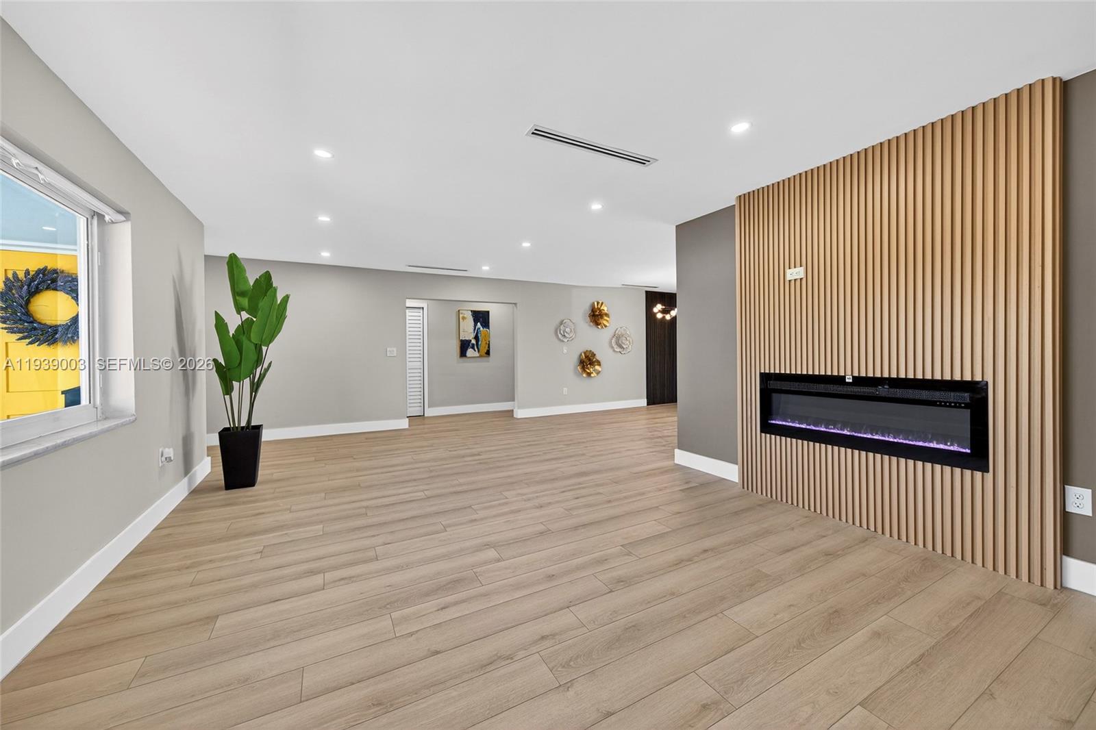 4712 Cleveland Street Hollywood, FL 33021 - Photo 8 of 49 a view of an empty room with wooden floor and a window