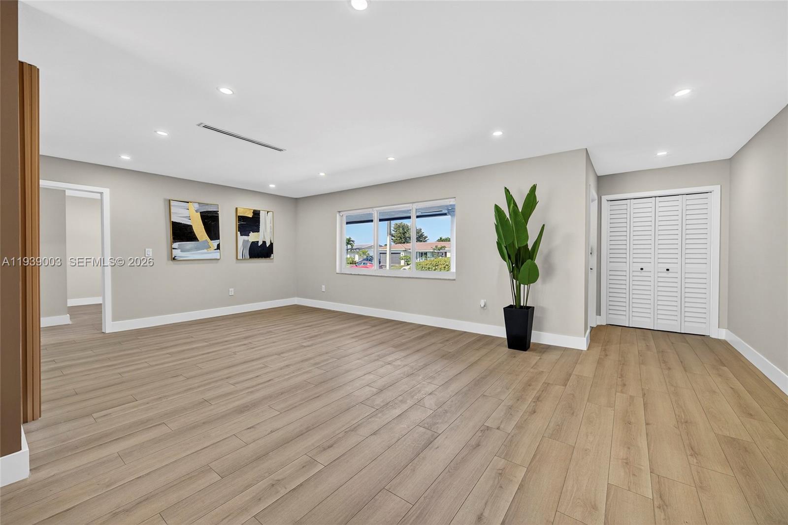 4712 Cleveland Street Hollywood, FL 33021 - Photo 9 of 49 a view of an empty room with wooden floor and a window