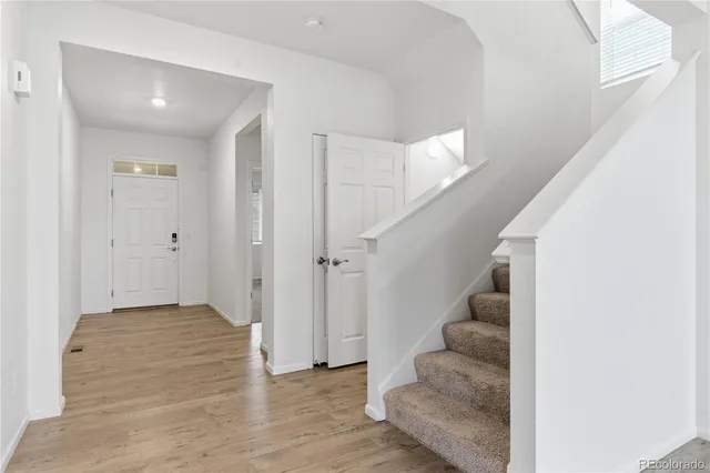 a view of entryway and hall with wooden floor