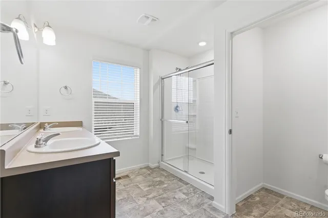 a bathroom with a sink a shower and a mirror