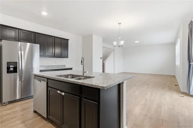 a kitchen with a sink a refrigerator and a stove