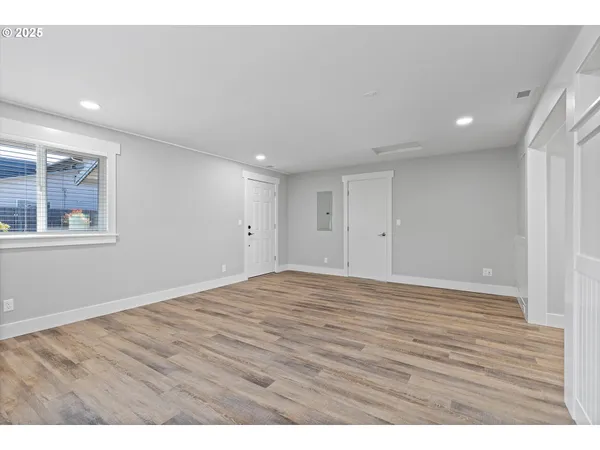 a view of an empty room with wooden floor