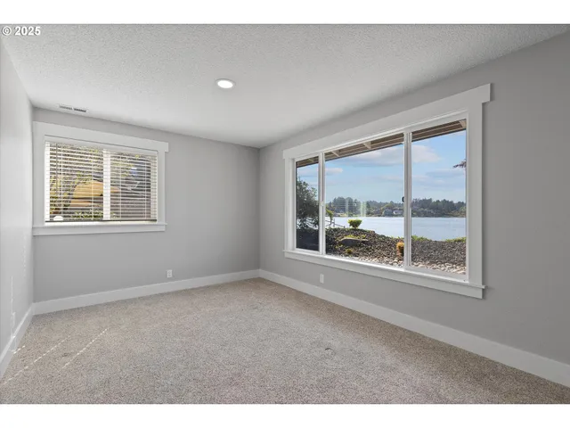 a big room with wooden floor and windows
