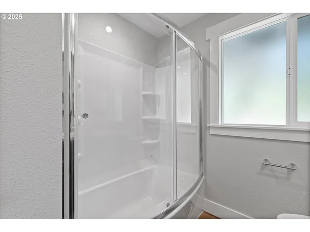 a bathroom with a shower and a tub