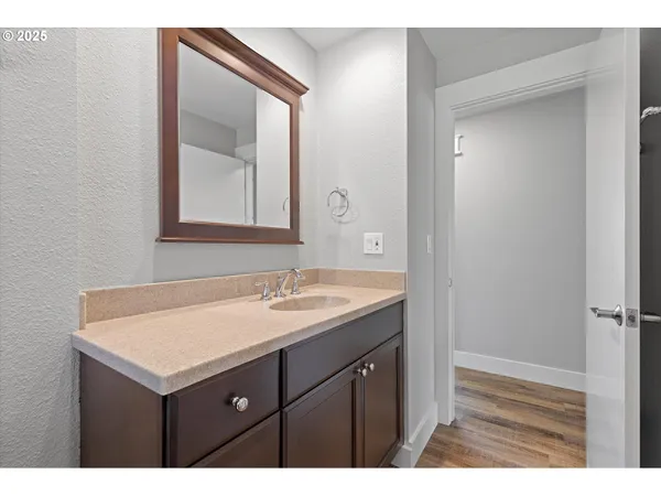 a bathroom with a sink vanity and mirror