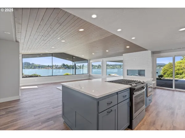 a kitchen with a sink and wooden floor