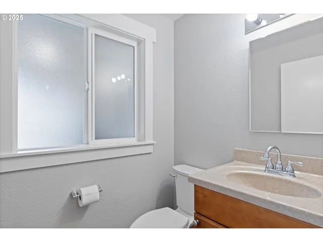 a bathroom with a sink vanity and mirror