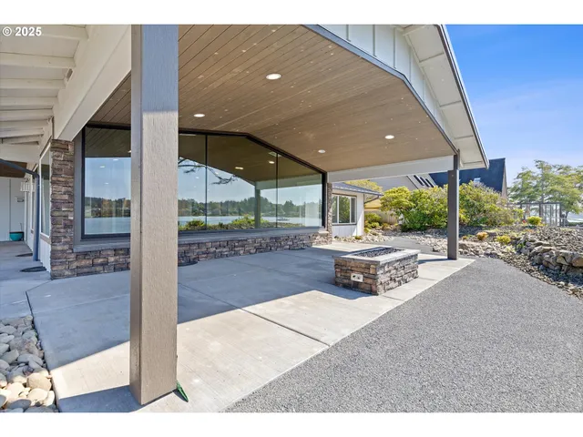 a building outdoor space with patio furniture and potted plants