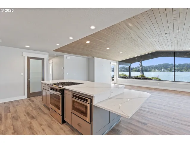 a open kitchen with a sink and wooden floor