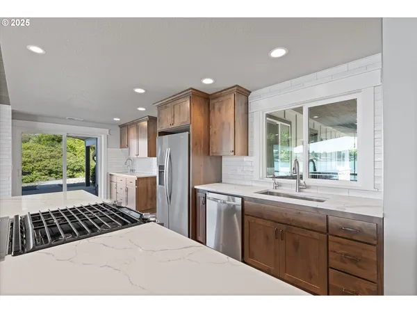 a kitchen with a sink stove and refrigerator