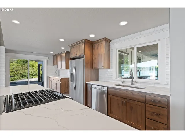 a kitchen with a sink stove and refrigerator