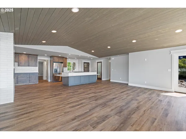 a view of kitchen and hall with wooden floor