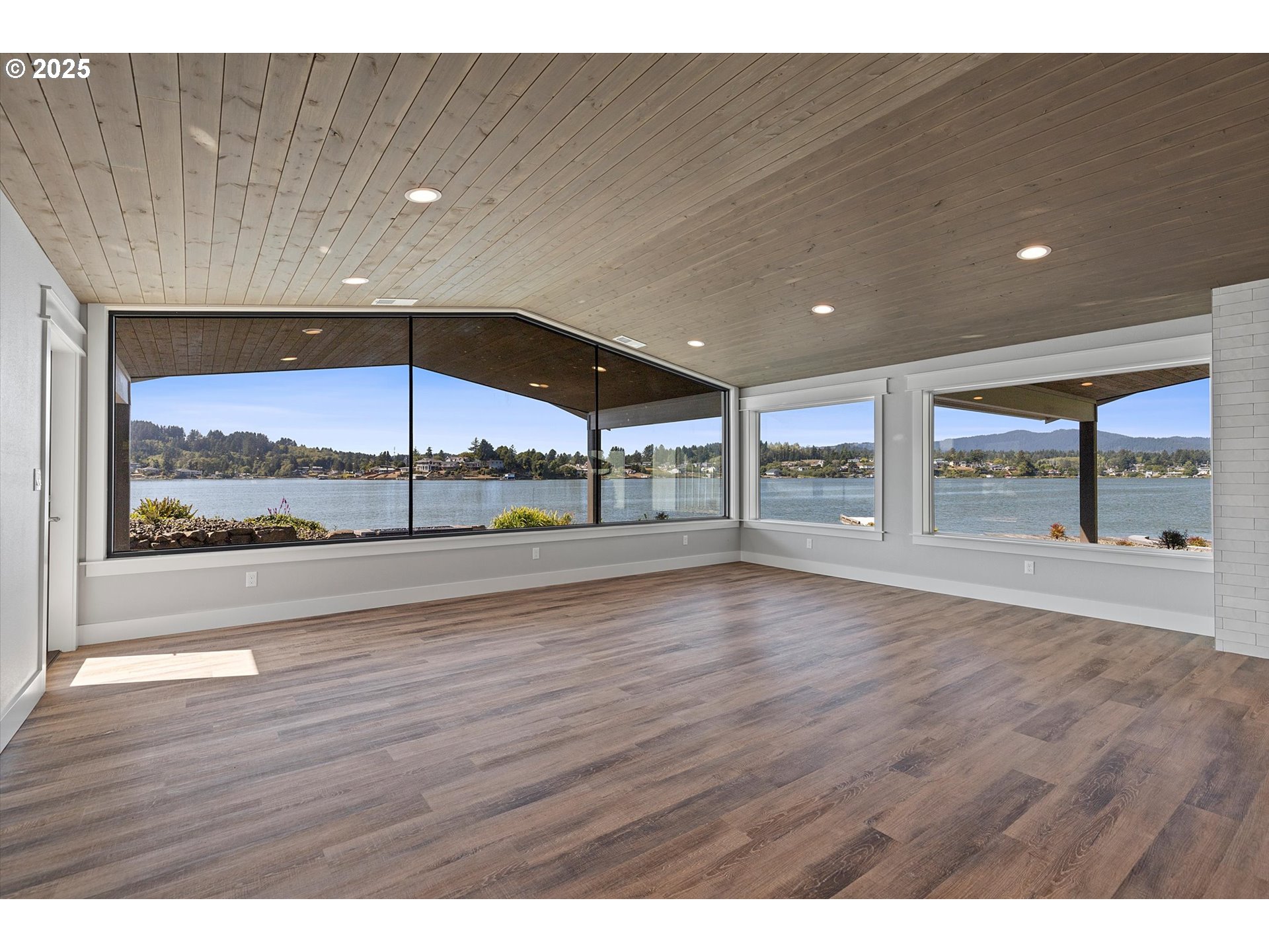 2997 Northeast Loop Drive Otis, OR 97368 - Photo 9 of 35 a view of an empty room with wooden floor and a large window