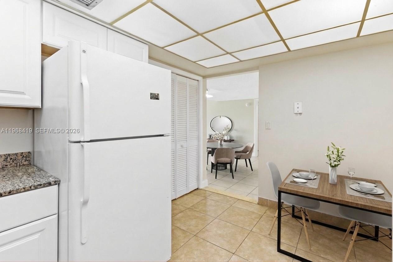 16400 Golf Club Road, Unit 104 Weston, FL 33326 - Photo 11 of 24 a view of kitchen with furniture and refrigerator