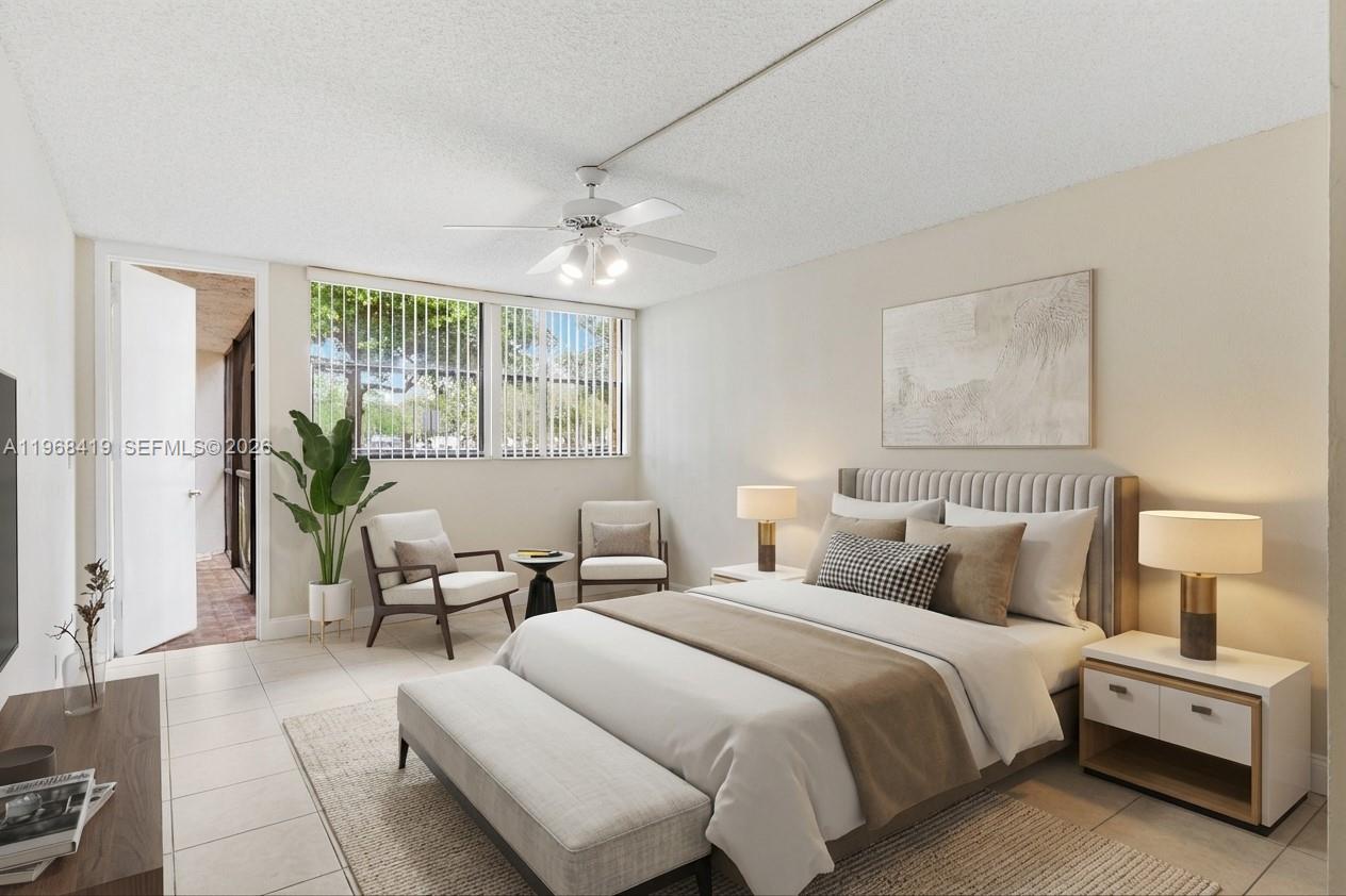 16400 Golf Club Road, Unit 104 Weston, FL 33326 - Photo 15 of 24 a bedroom with a bed and a couch