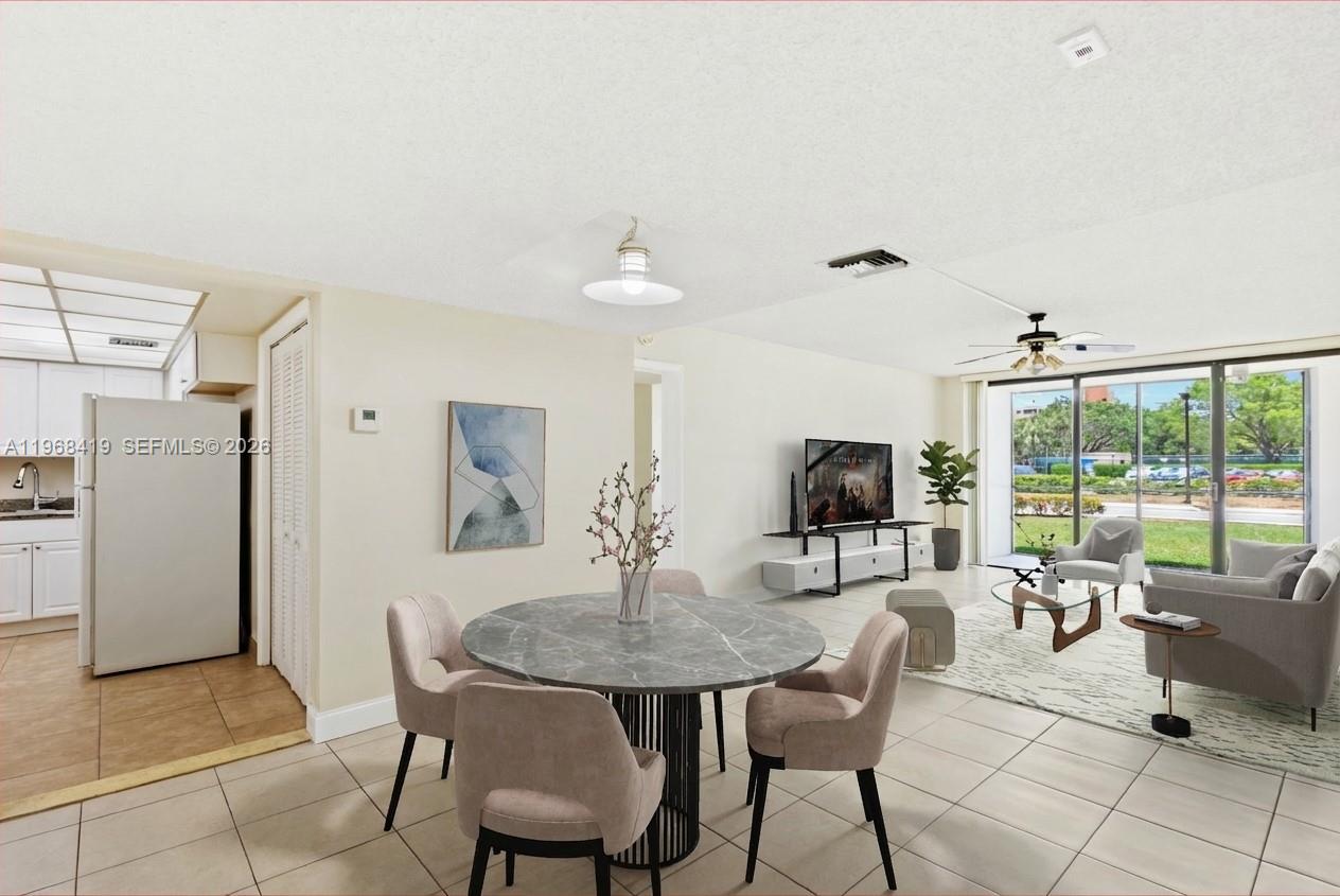 16400 Golf Club Road, Unit 104 Weston, FL 33326 - Photo 8 of 24 a living room with furniture and a flat screen tv