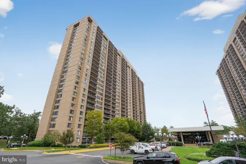 a view of a tall building next to a yard