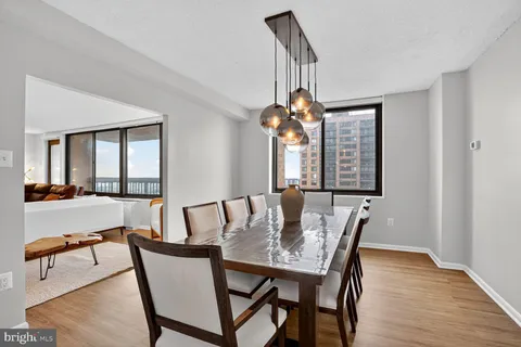 a view of a dining room with furniture wooden floor and a chandelier