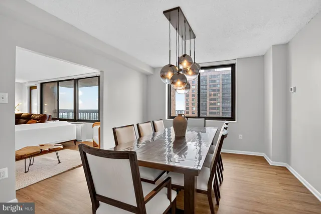 a view of a dining room with furniture wooden floor and a chandelier