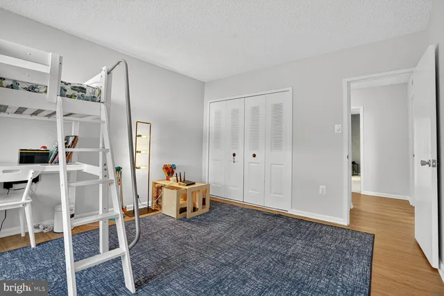 a bedroom with furniture and baby crib