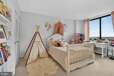 a bed room with furniture and a baby crib