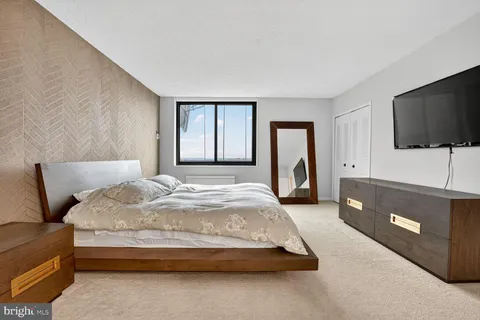 a bedroom with a bed and window