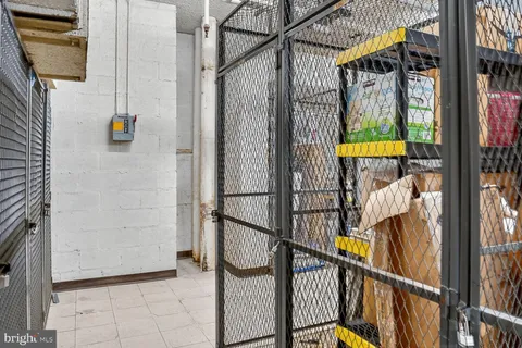a living room with fireplace furniture and a dining table with wooden floor