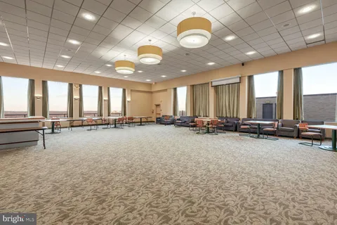 a room with pool table and windows