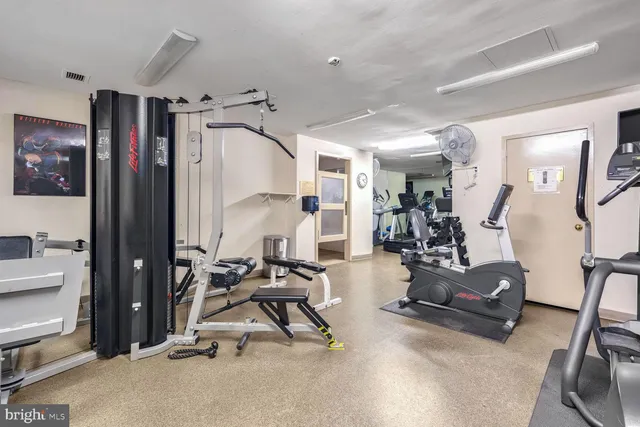 a view of a room with lots of white furniture and a chandelier
