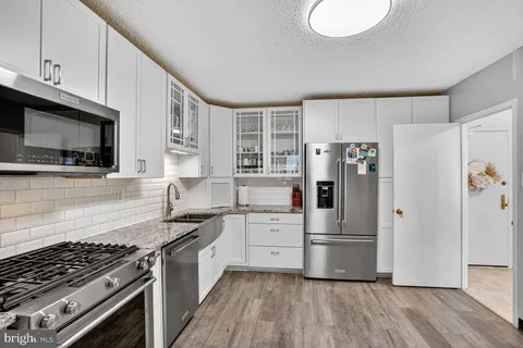 a kitchen with stainless steel appliances a refrigerator stove and sink