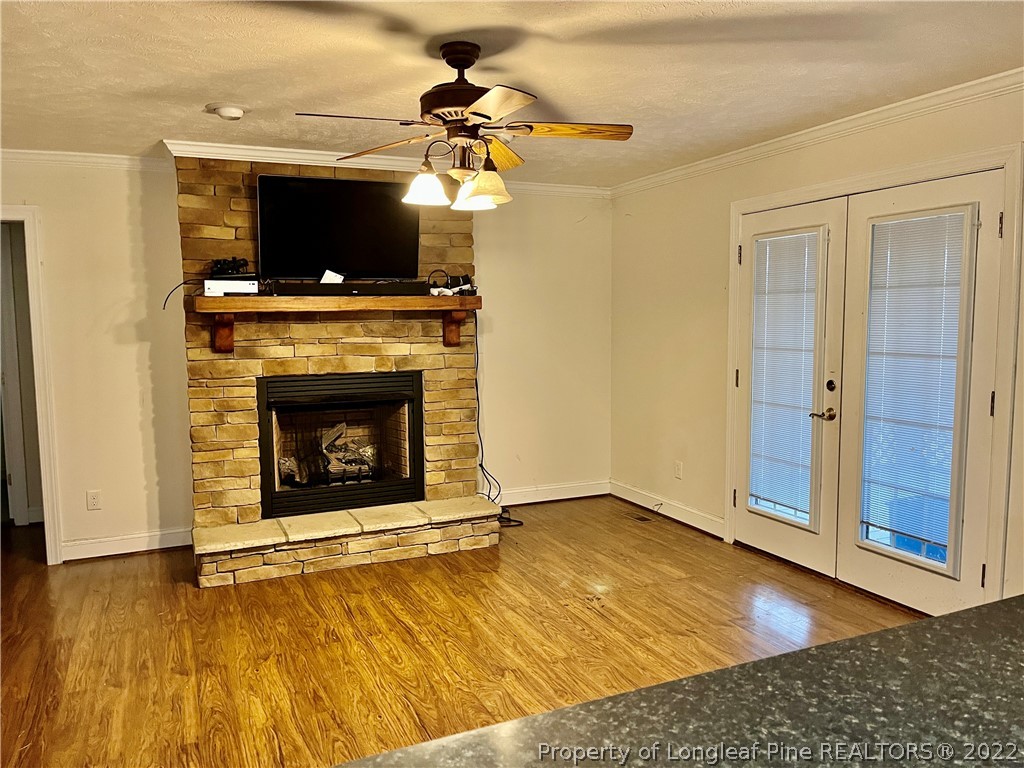 3140 Wade-Stedman Road Stedman, NC 28391 - Photo 15 of 36 a view of a livingroom with a fireplace and ceiling fan