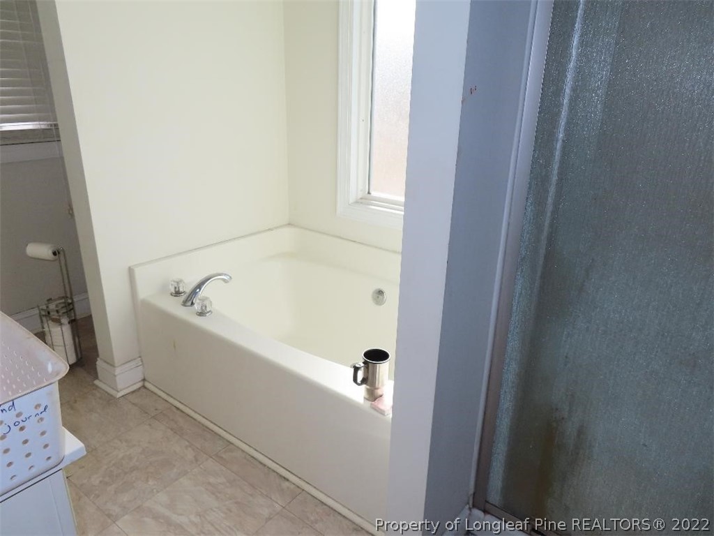3140 Wade-Stedman Road Stedman, NC 28391 - Photo 18 of 36 a bathroom with a bathtub