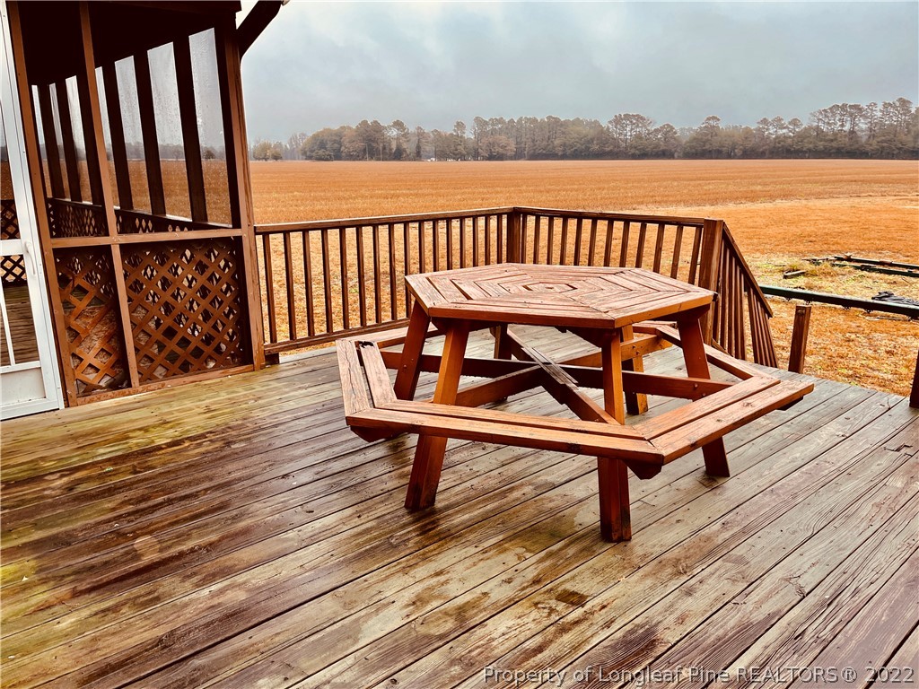 3140 Wade-Stedman Road Stedman, NC 28391 - Photo 29 of 36 a view of a roof deck with wooden floor and seating space