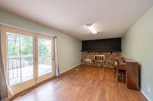 a view of a livingroom with furniture wooden floor and window