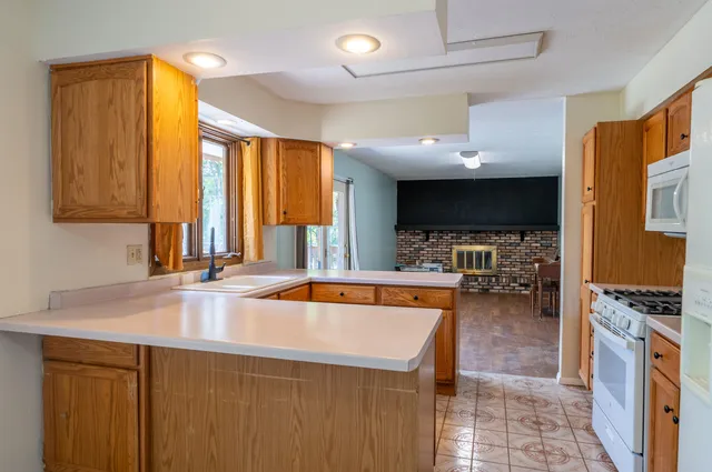 a kitchen with stainless steel appliances a stove a sink and a microwave