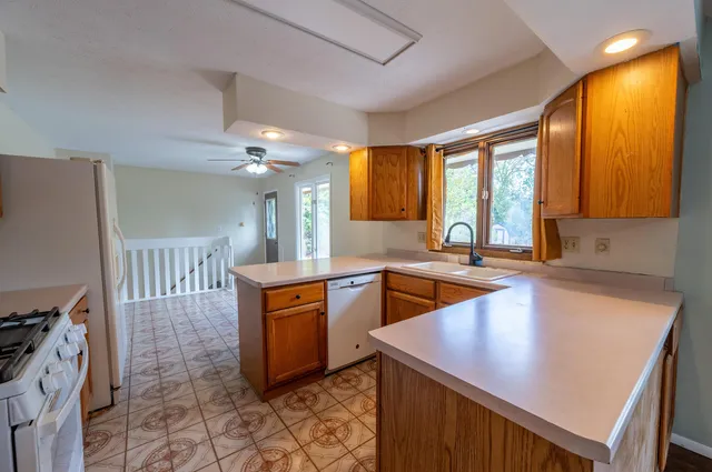 a kitchen with stainless steel appliances granite countertop a sink counter space and a stove