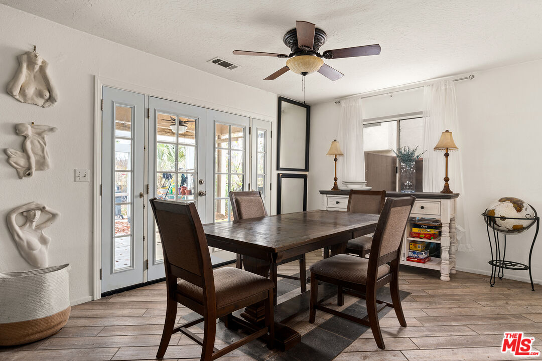 12960 Greensboro Road Victorville, CA 92395 - Photo 12 of 34 a view of a dining room with furniture window and wooden floor